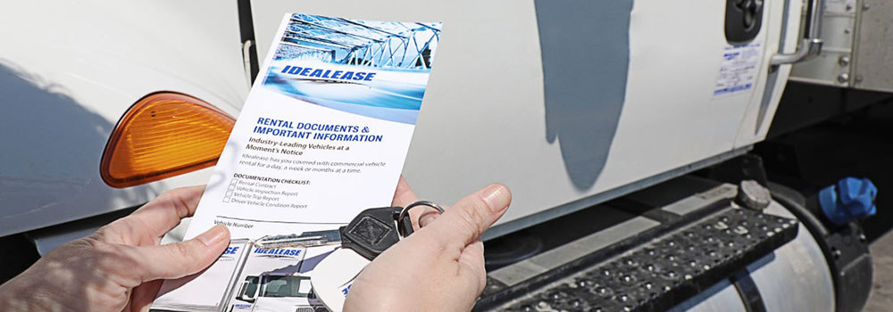 Hands holding rental documents and keys